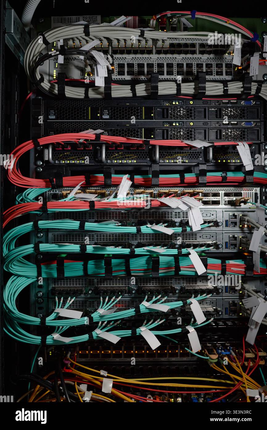 Network Server Rack Displaying Data Cables and Hardware Equipment Operating Stock Photo