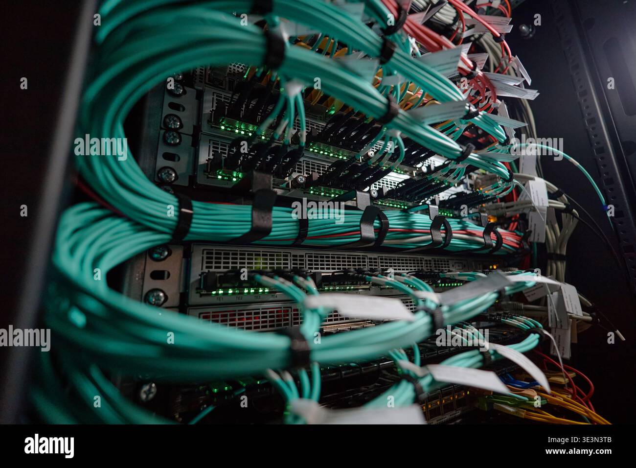 Network Server Rack Displaying Cables and Hardware Components Operating Stock Photo