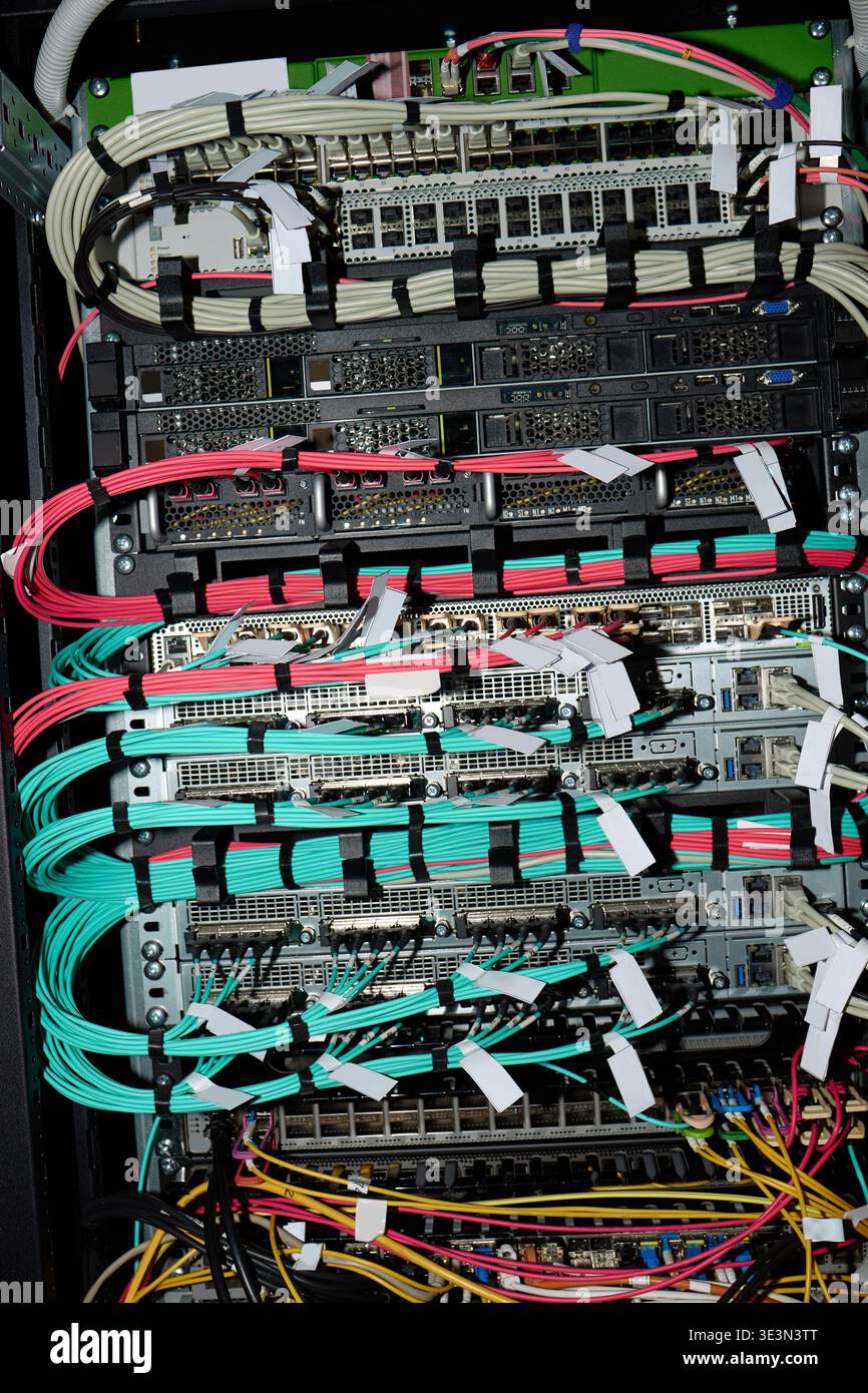 Network Server Rack Showing Organized Ethernet Cables and Hardware Connections Stock Photo
