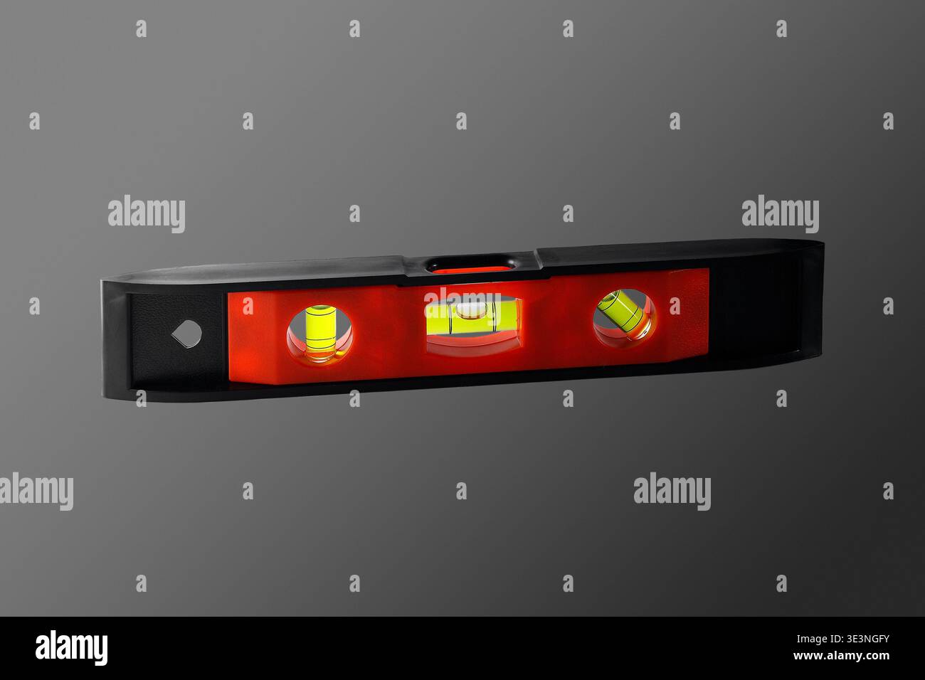 Plastic small building level. Close-up. Isolated on grey background. Stock Photo