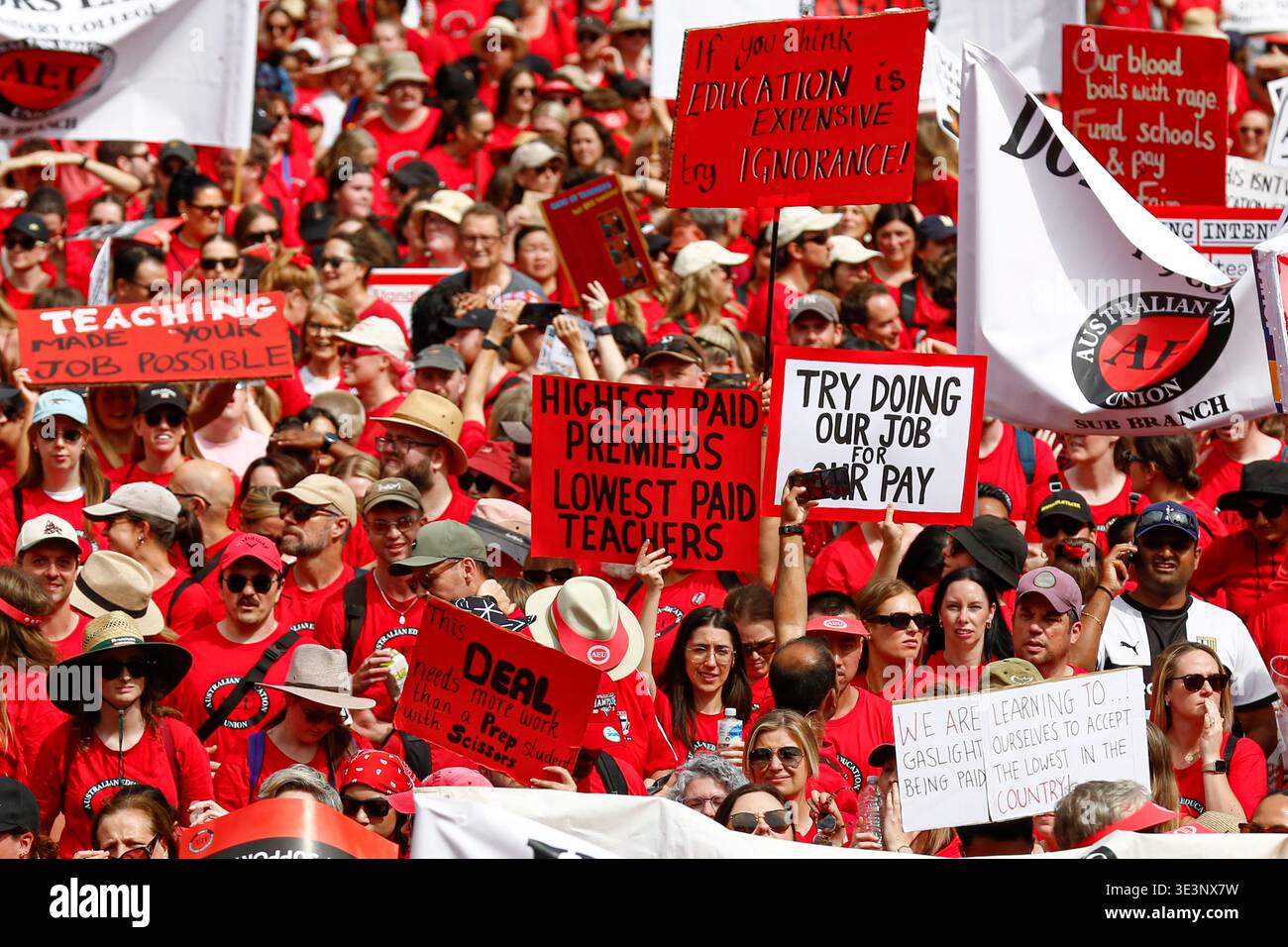 Protesters hold placards during the rally. Tens of thousands of public ...