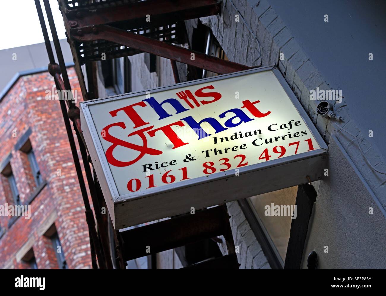 This & That Indian Cafe sign on Soap Street in Manchester’s Northern Quarter, home of rice and three curries since 1984 when established Stock Photo