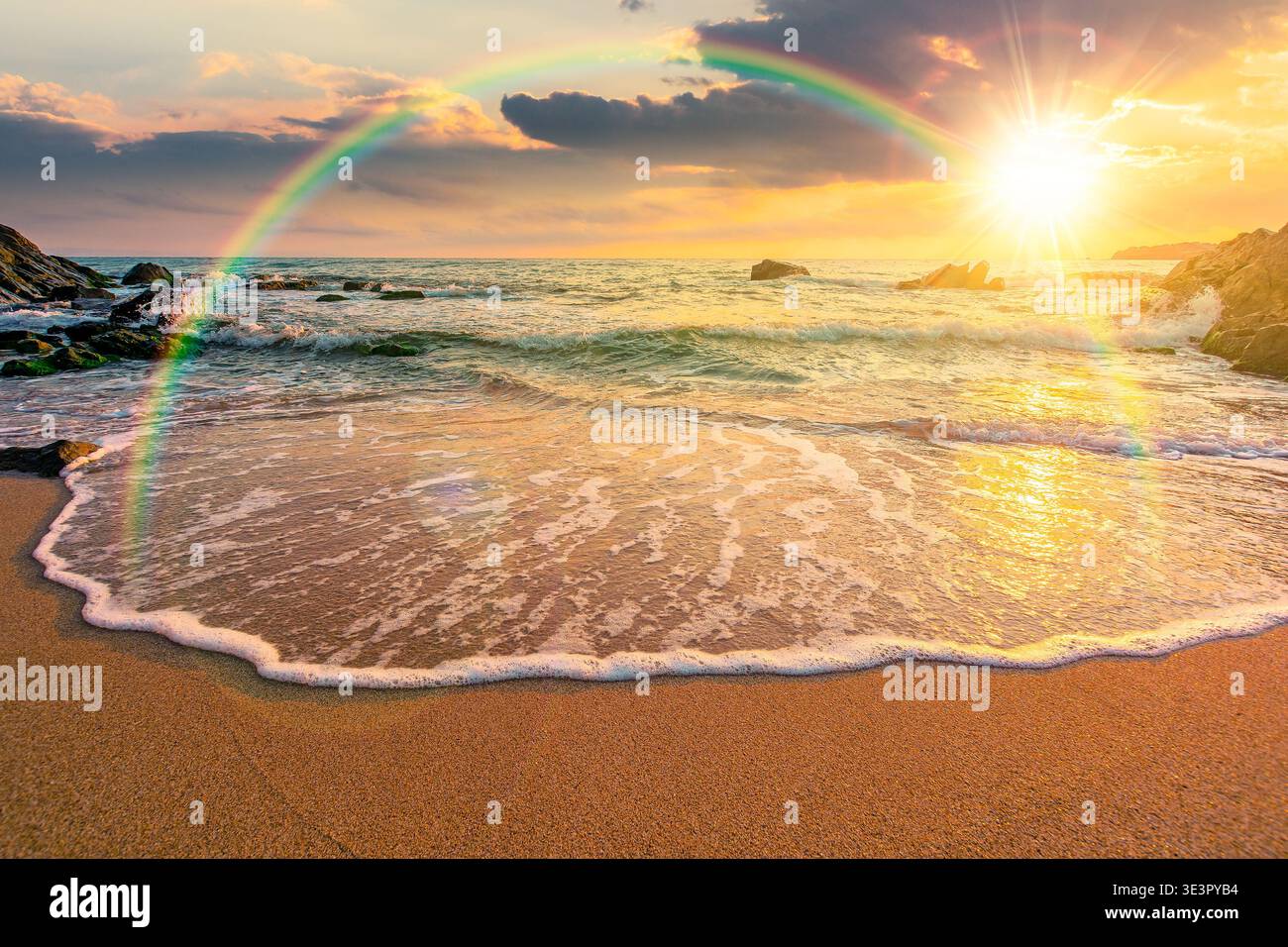 sunset over sandy sea beach. scene on hot summer vacation season. beautiful view of waves washing the sand. generic image of seascape and sky with rai Stock Photo