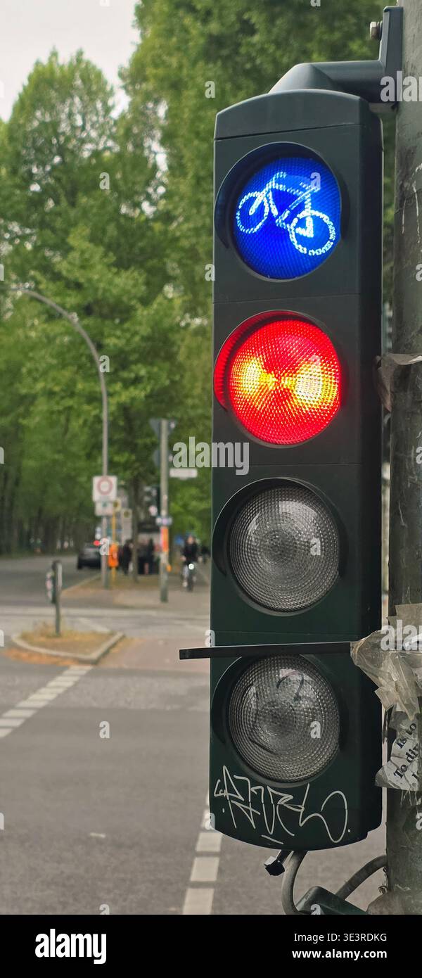 Belin, Germany - May 19, 2025: Bicycle traffic light displays blue bike signal and red stop light for cyclists. - Smartphone Captured Stock Image