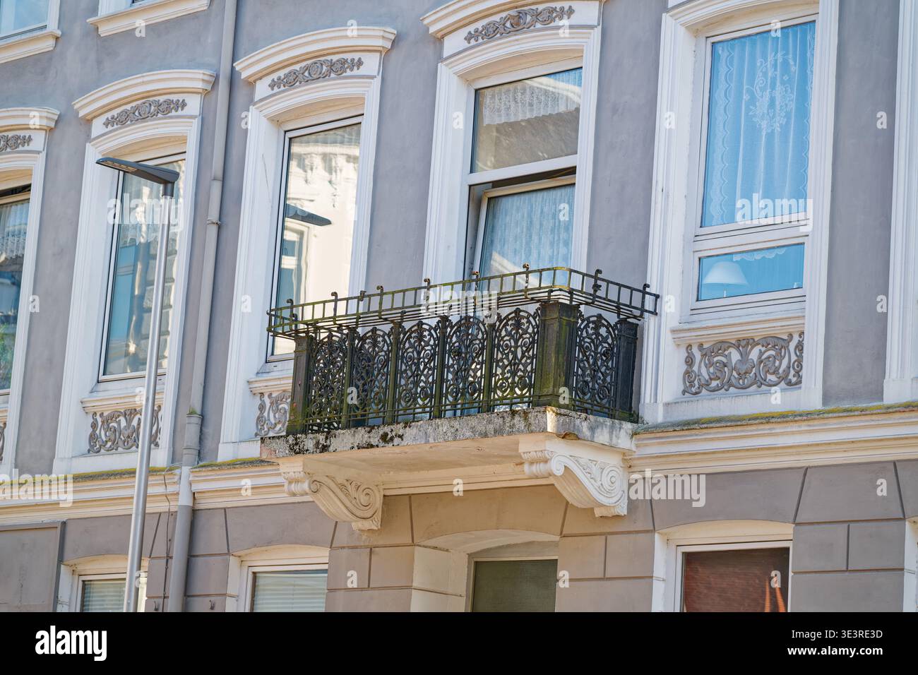 Facade of a historic building featuring a decorative iron balcony and ...
