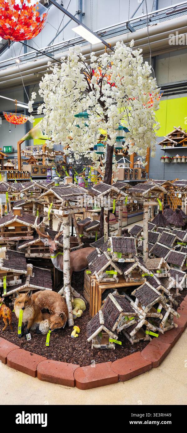 Berlin, Germany - August 06, 2025: . Decorative garden scene features wooden animal houses and a white tree - Smartphone Captured Stock Image