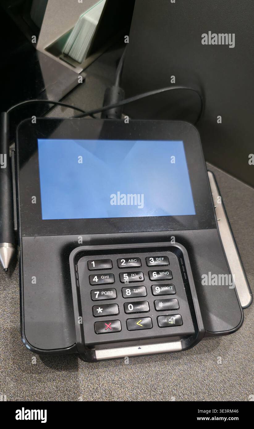 Berlin, Germany - August 11, 2025: Black payment terminal features a blank screen and keypad layout for transactions. - Smartphone Captured Stock Image