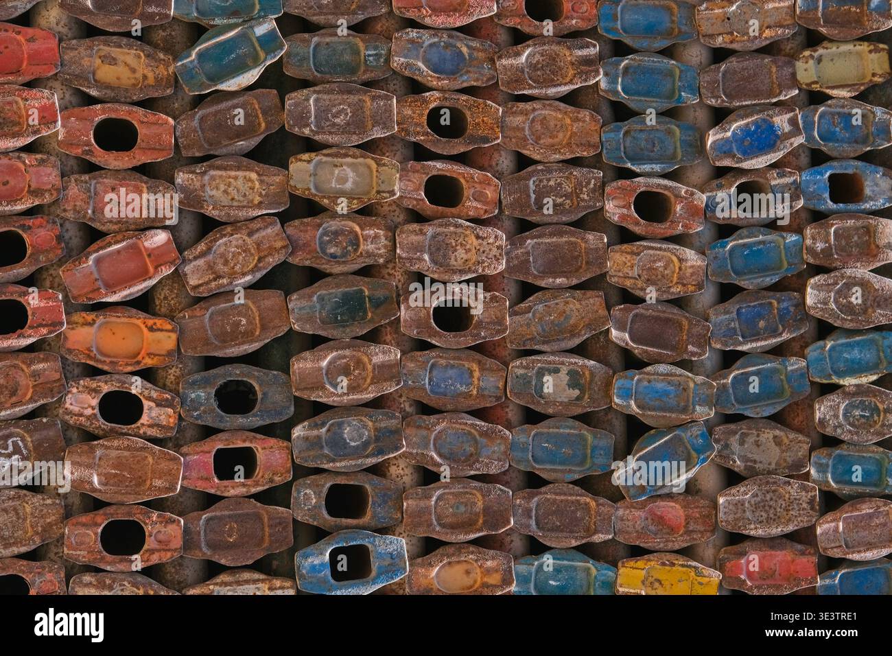 Rusty metal scaffolding components arranged in repeating pattern. Industrial texture background  Stock Photo