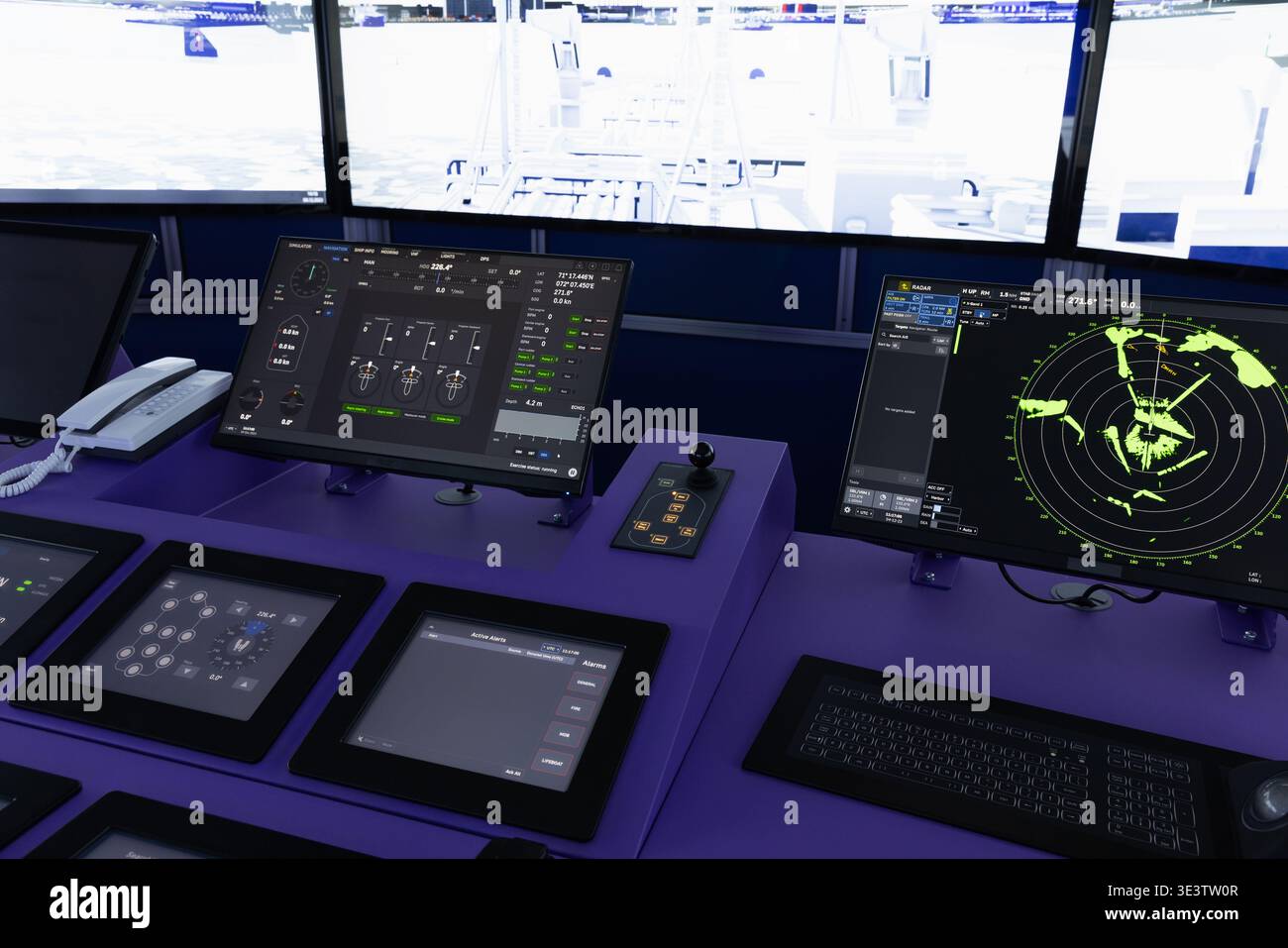 Modern ship bridge navigation console featuring a radar screen, electronic control panel, handsets and communication equipment, illustrating maritime Stock Photo