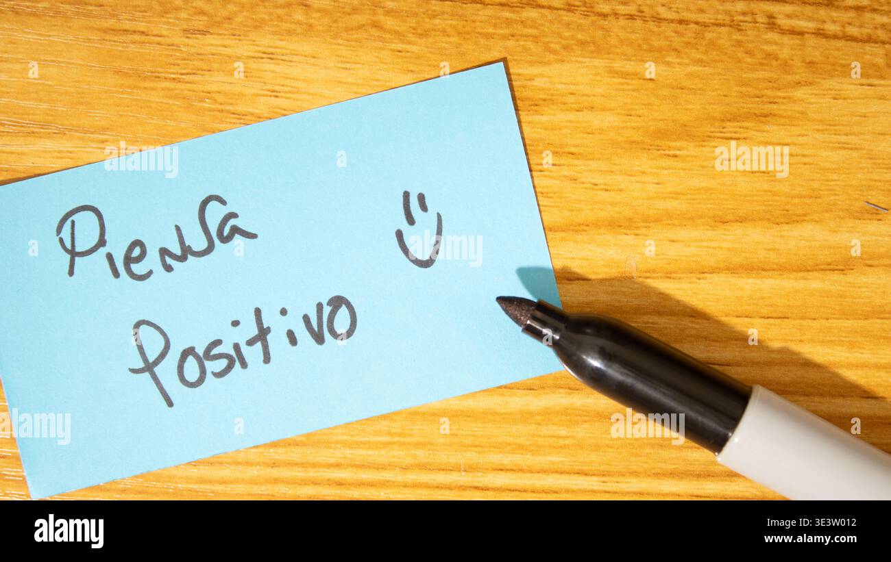 Sticky note or yellow note with the word "think positive" written on it Stock Photo