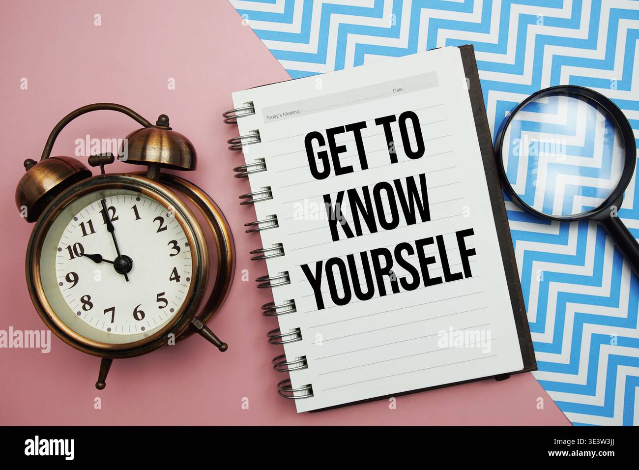 Get To Know Yourself text written on notepad with alarm clock and magnifying glass Stock Photo