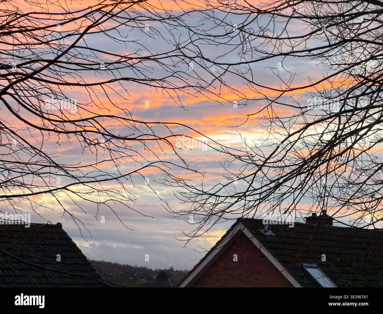 Stunning Vivid Spring Sunset  Over Residential Rooftops,Derbyshire.England.UK - Smartphone Captured Stock Image