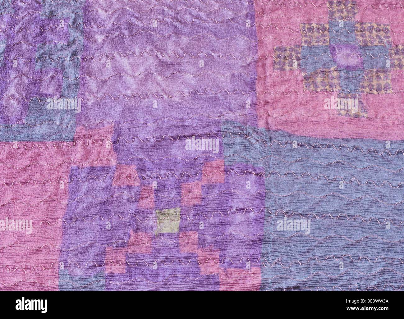 Textile background stitched silk pieces in patchwork scarf Stock Photo