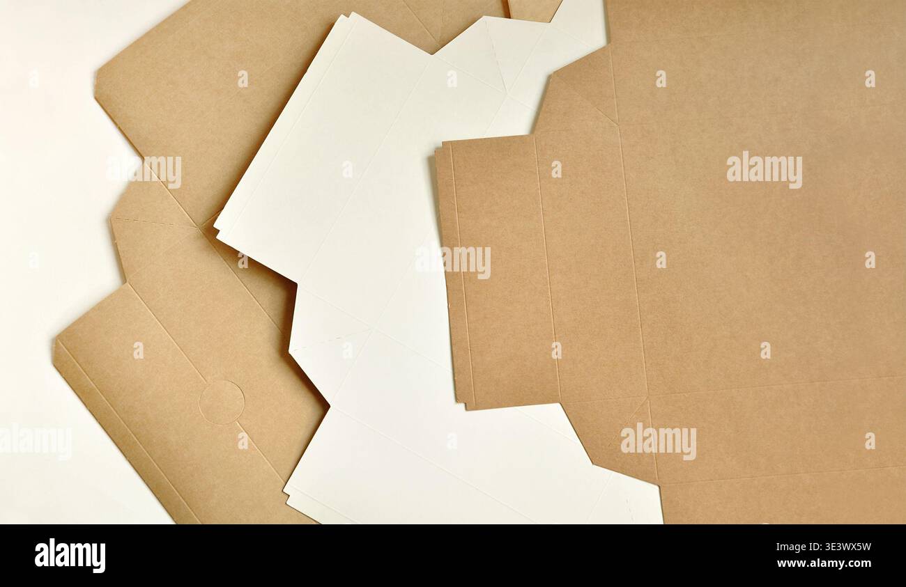 Cardboard brown boxes, unfolded, layered. Abstract artistic background. Sustainable packaging concept, packaging template, wood, paper industry Stock Photo