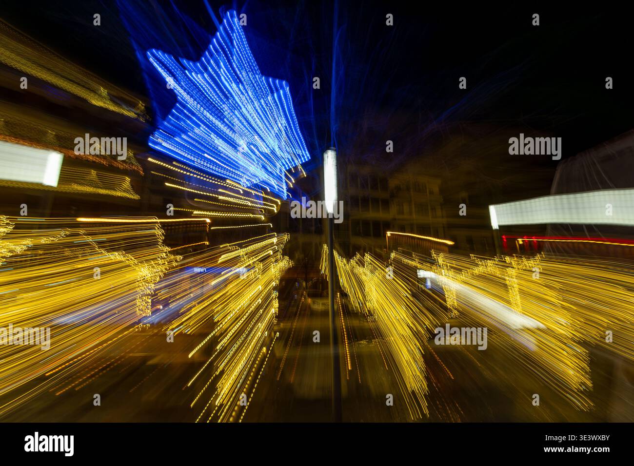 Abstract view of Christmas lights with dynamic motion blur creating a vibrant festive background. Stock Photo