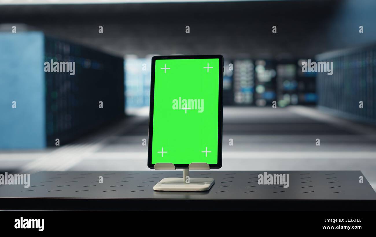 Green screen tablet in data center used for doing maintenance on infrastructure, improving workload. Mockup device in server farm used by high tech server clusters for parallel processing Stock Photo