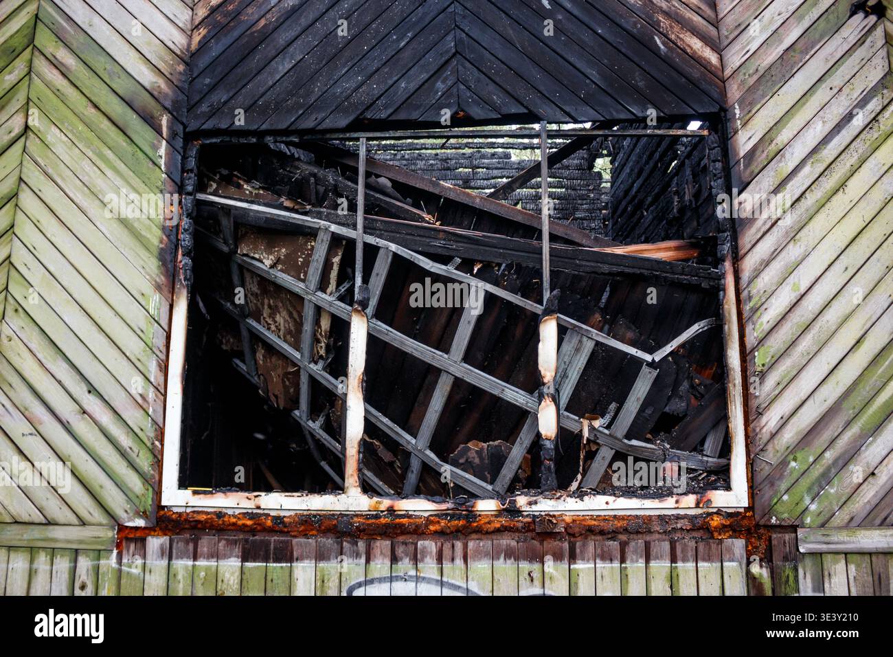 Fire Ravaged Charred Charred window frame in a ravaged building, revealing dark, fire ...