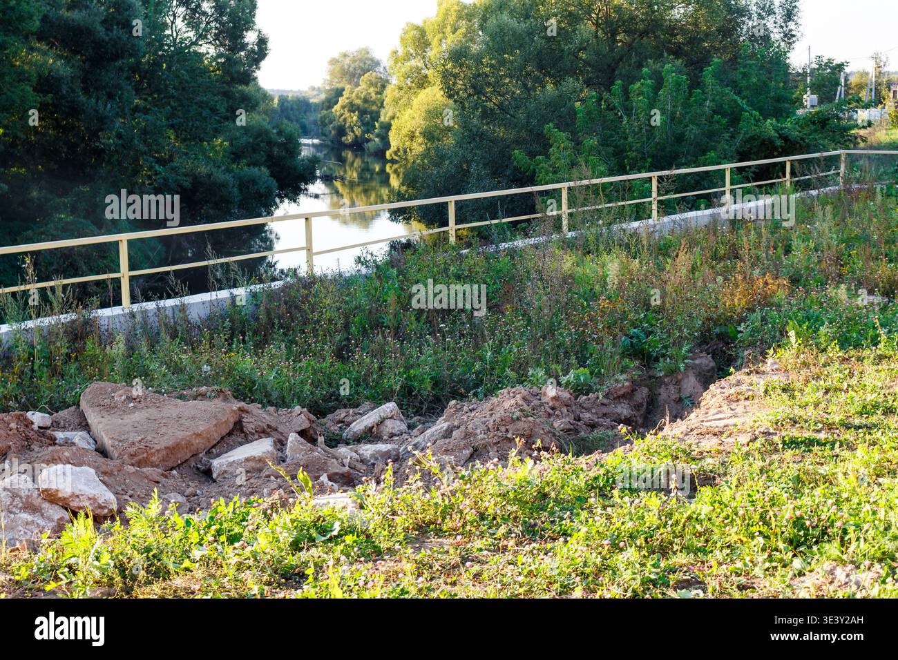 Rubble Railing River slope erosion control with concrete rubble and dirt. A sturdy ...