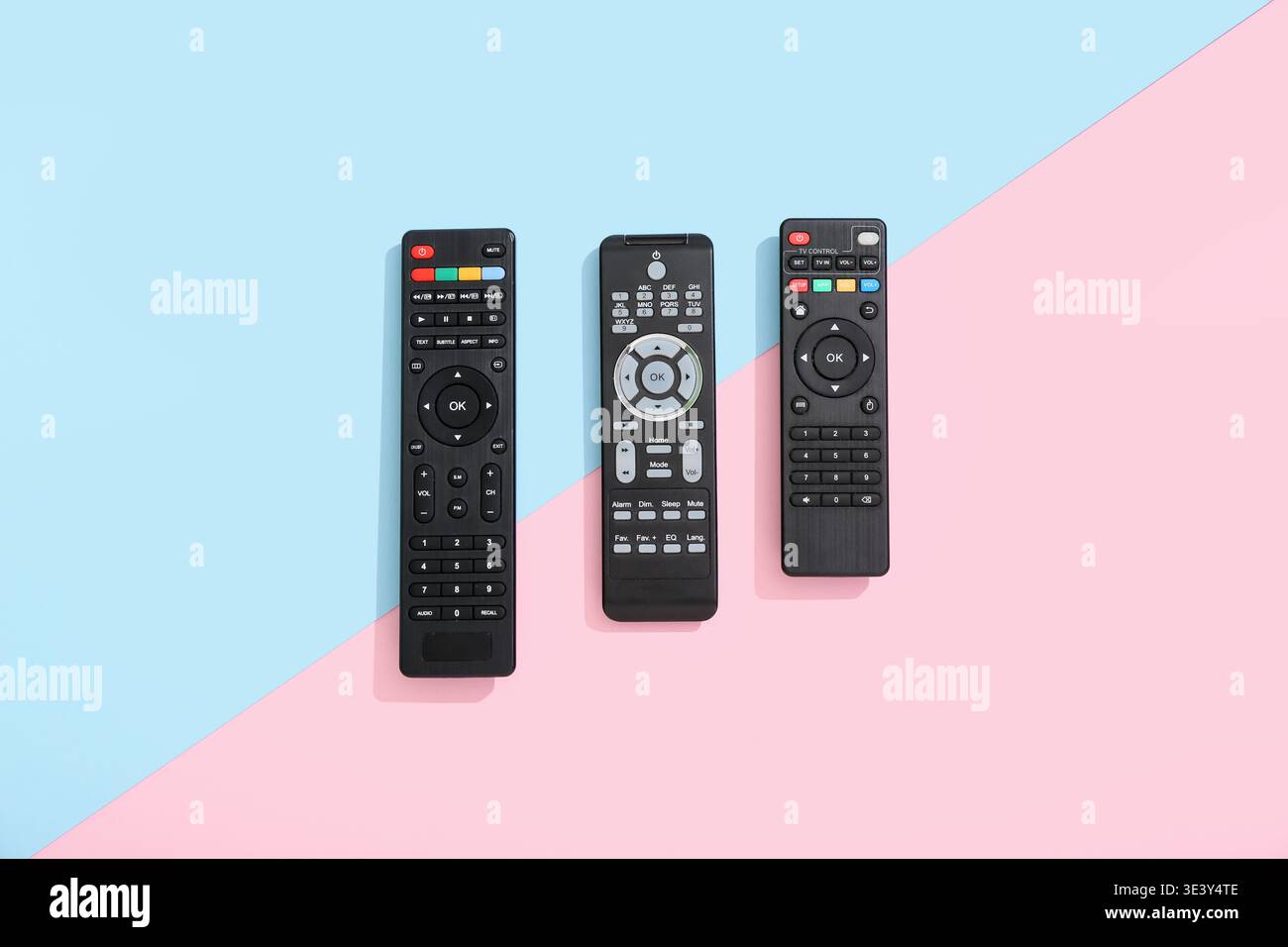 Different modern TV remote controls on color background Stock Photo