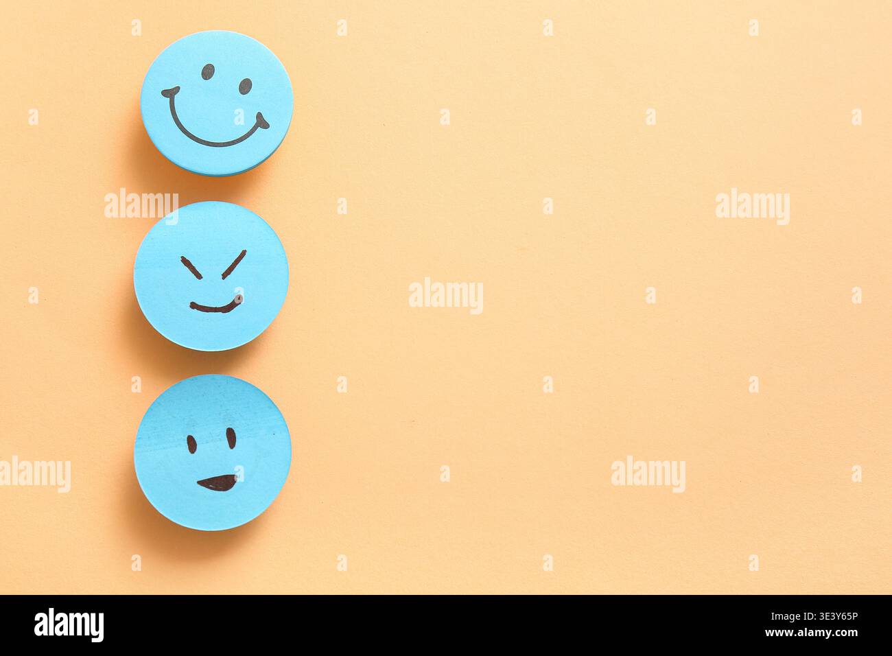 Sticky notes with smiley faces on orange background Stock Photo