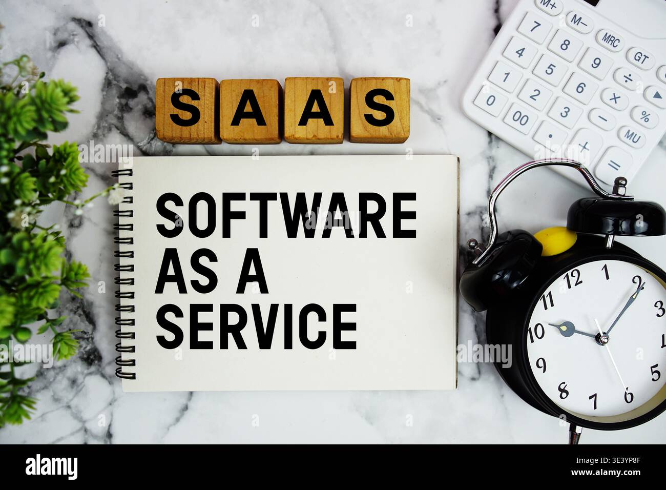 SAAS Software As A Service Is A Software text with calculator and alarm clock on marble background Stock Photo