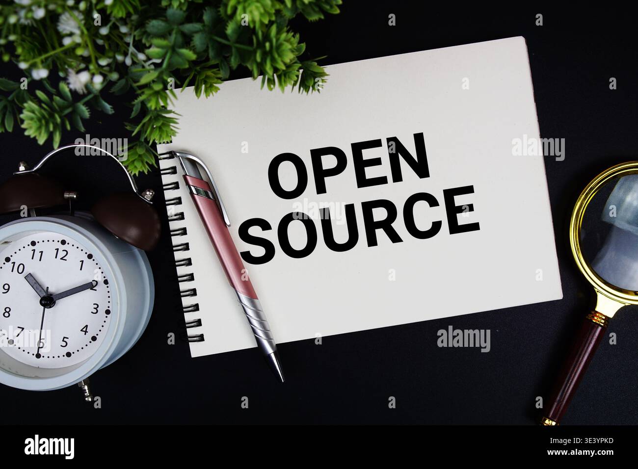 Open Source text with alarm clock and magnifying glass Stock Photo