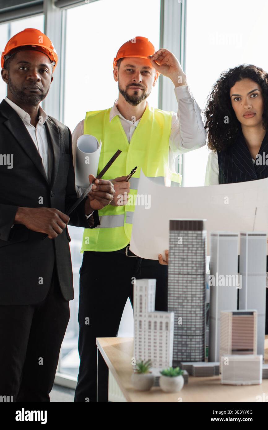 Architects Reviewing Building Plans Stock Photo