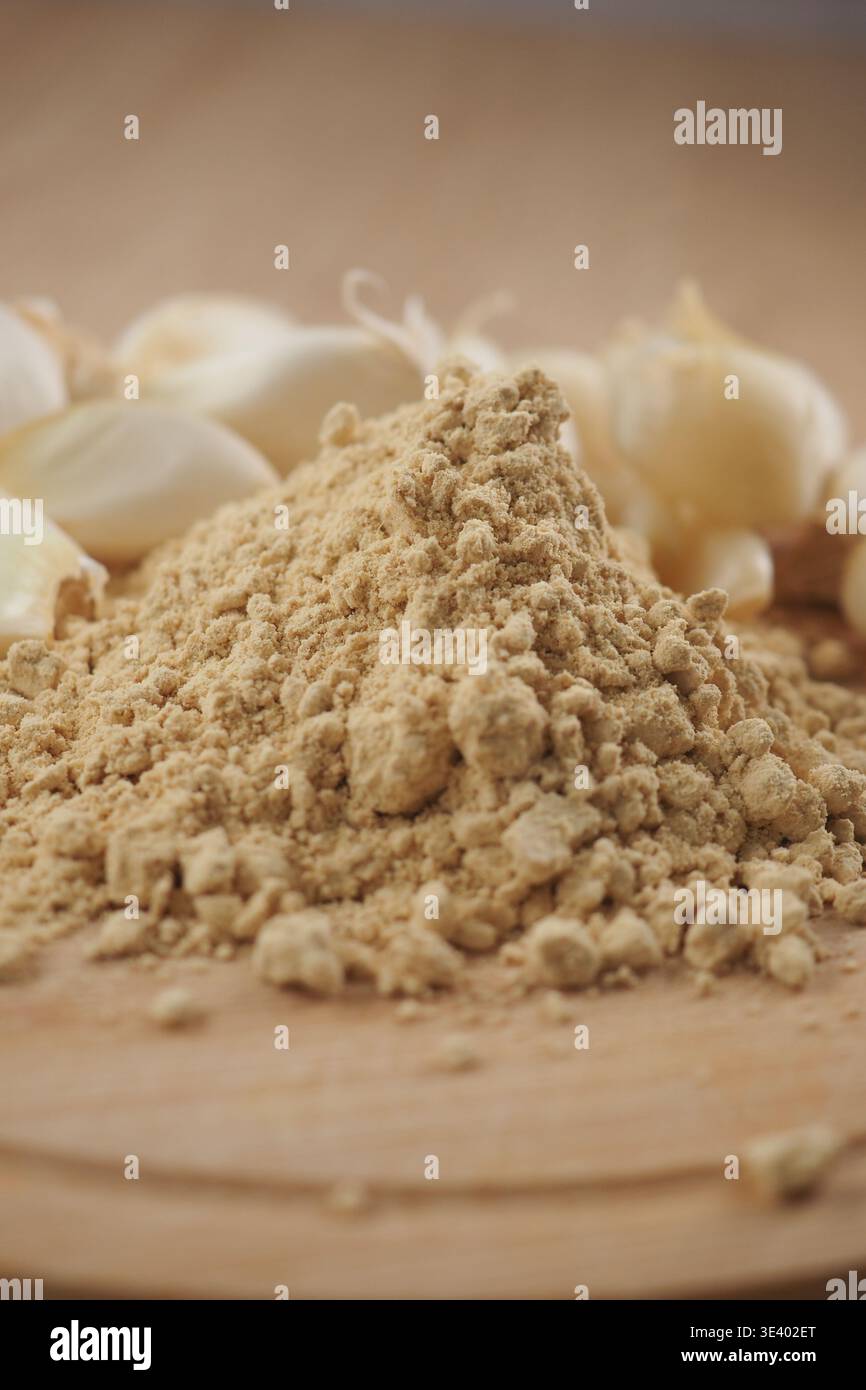 Ground ginger and garlic on wooden kitchen surface Stock Photo