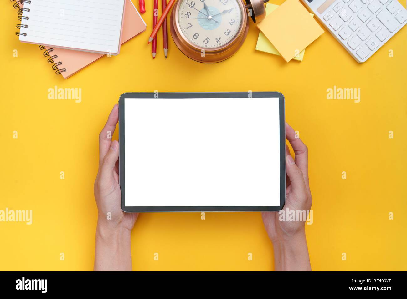 Tablet and school supplies on yellow background Stock Photo