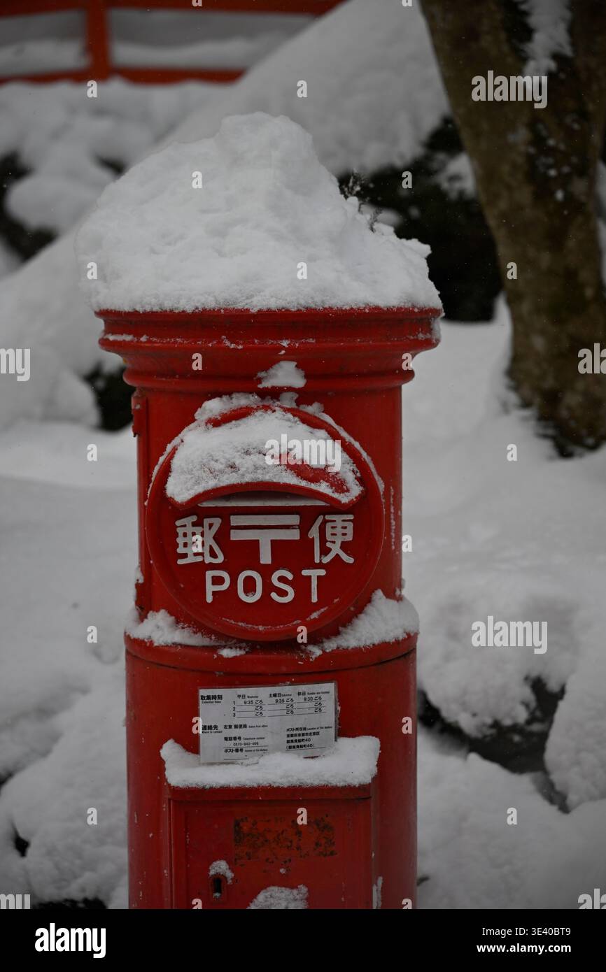 Red post box in the snow,Japan. Stock Photo