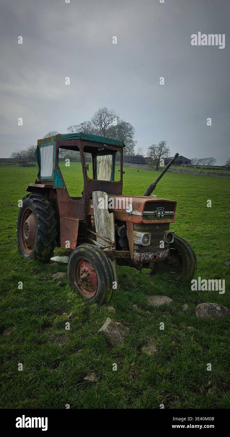 Massey Ferguson 135 tractor with Duncan style safety cab put out to pasture. Cumbria, England. - Smartphone Captured Stock Image