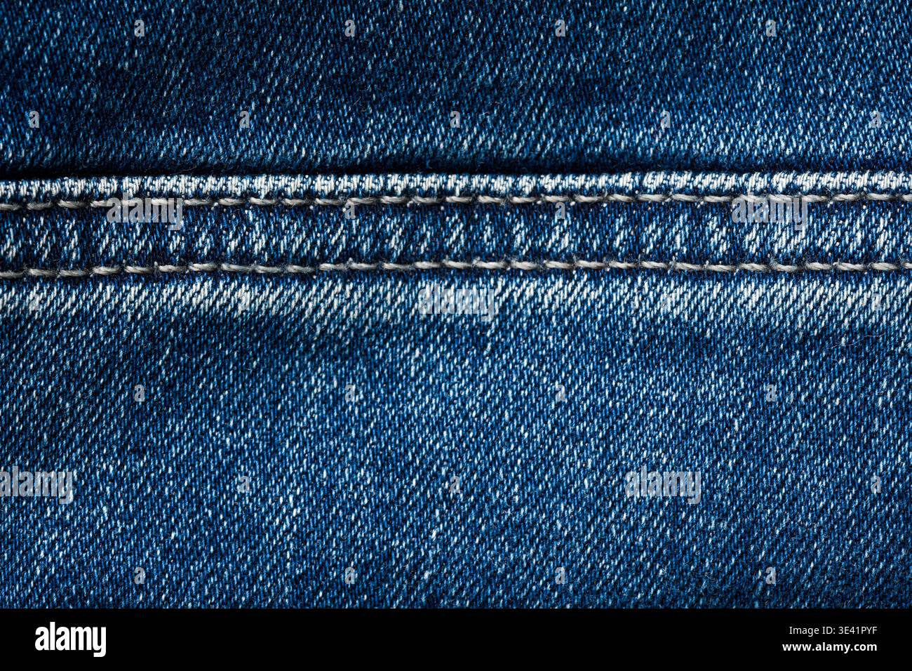 Detailed blue denim fabric texture background with visible stitching pattern Stock Photo