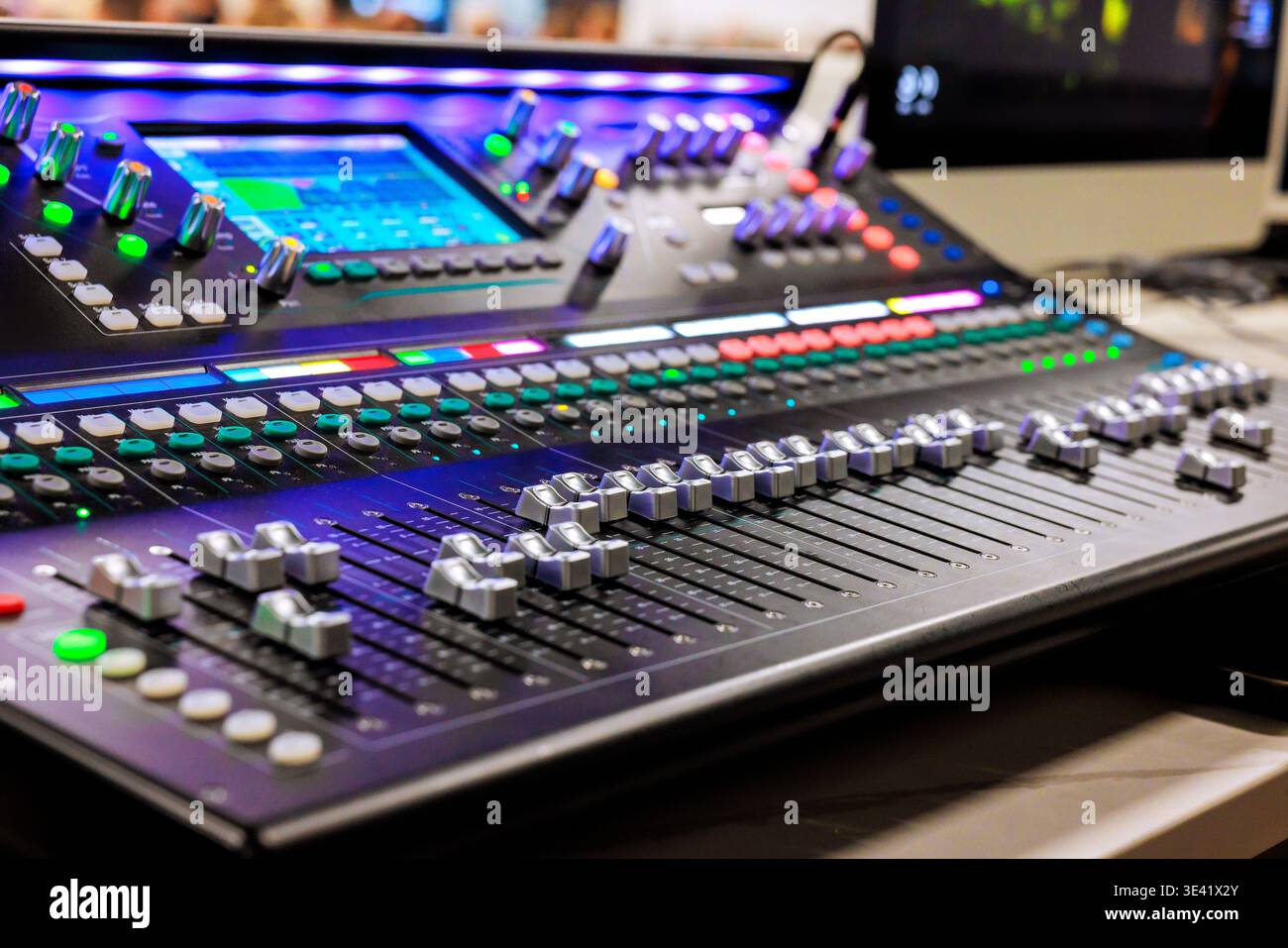 Recording studio features large mixing console with numerous controls, buttons during recording studio sound Stock Photo