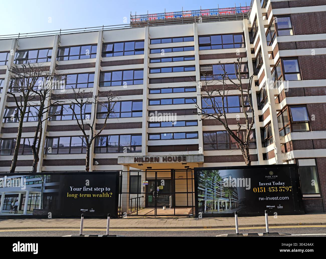 Hilden House, Warrington, marketed as Park View Residences, with off-plan buy-to-let hoardings as redevelopment into apartments begins. Stock Photo