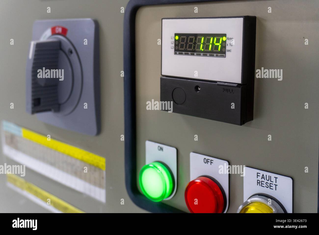 Digital display shows 88.88.114. Green light indicates system is active. Red button for emergency shutdown. Yellow button for fault reset. Panel has s Stock Photo