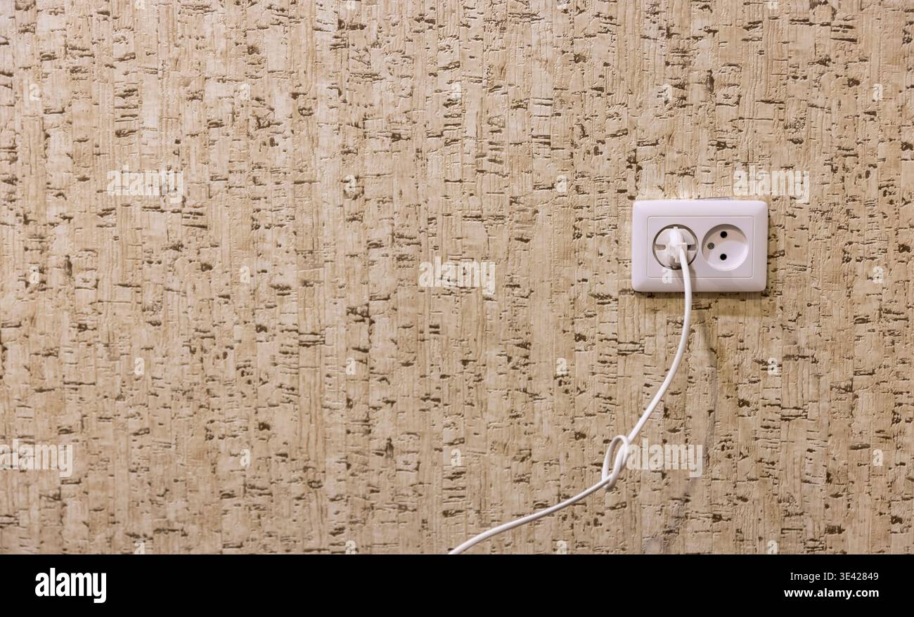 white double socket on a wall with wallpaper Stock Photo