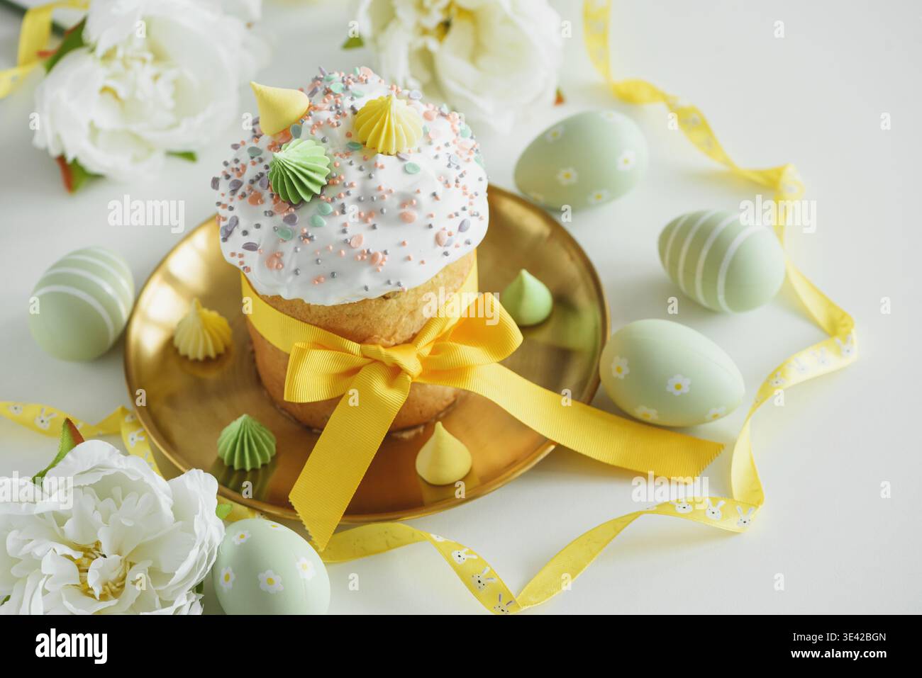 Easter Cake Decorated Yellow Ribbon with Flowers and Pastel Eggs on White Background Stock Photo