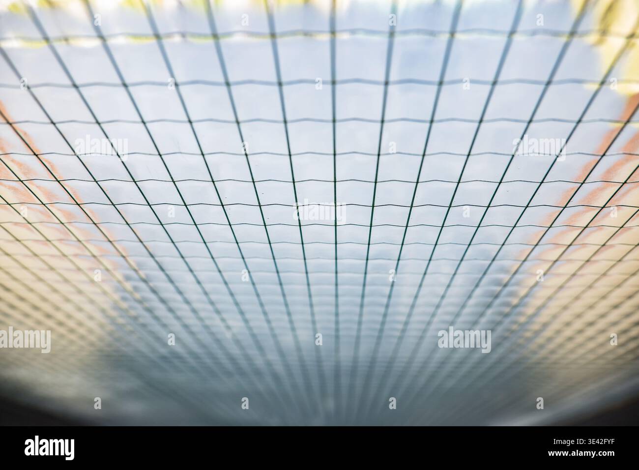Grid pattern creating a texture with converging lines, providing an abstract background Stock Photo