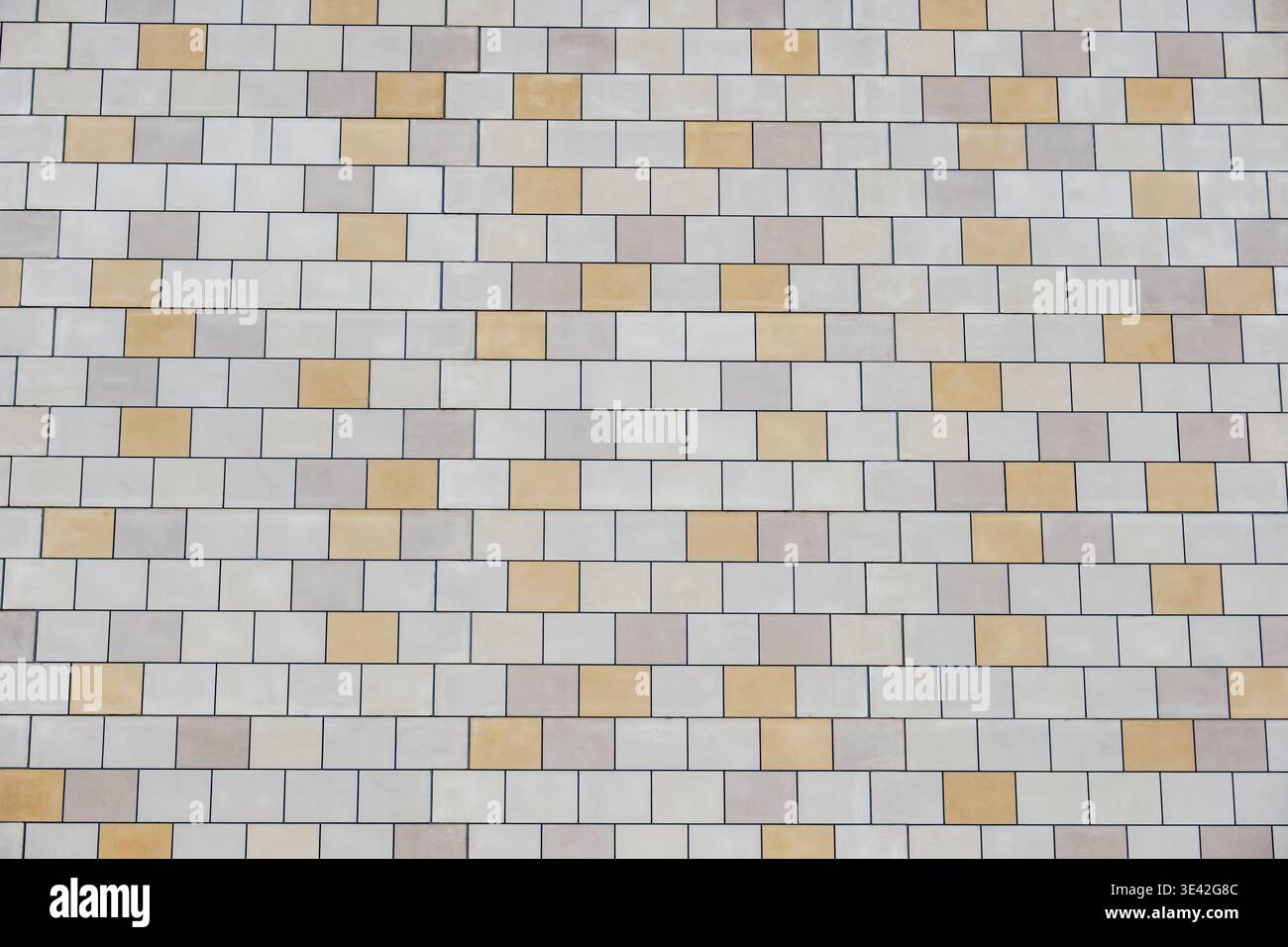 Ceramic tile wall background displaying beige and cream rectangular patterns Stock Photo