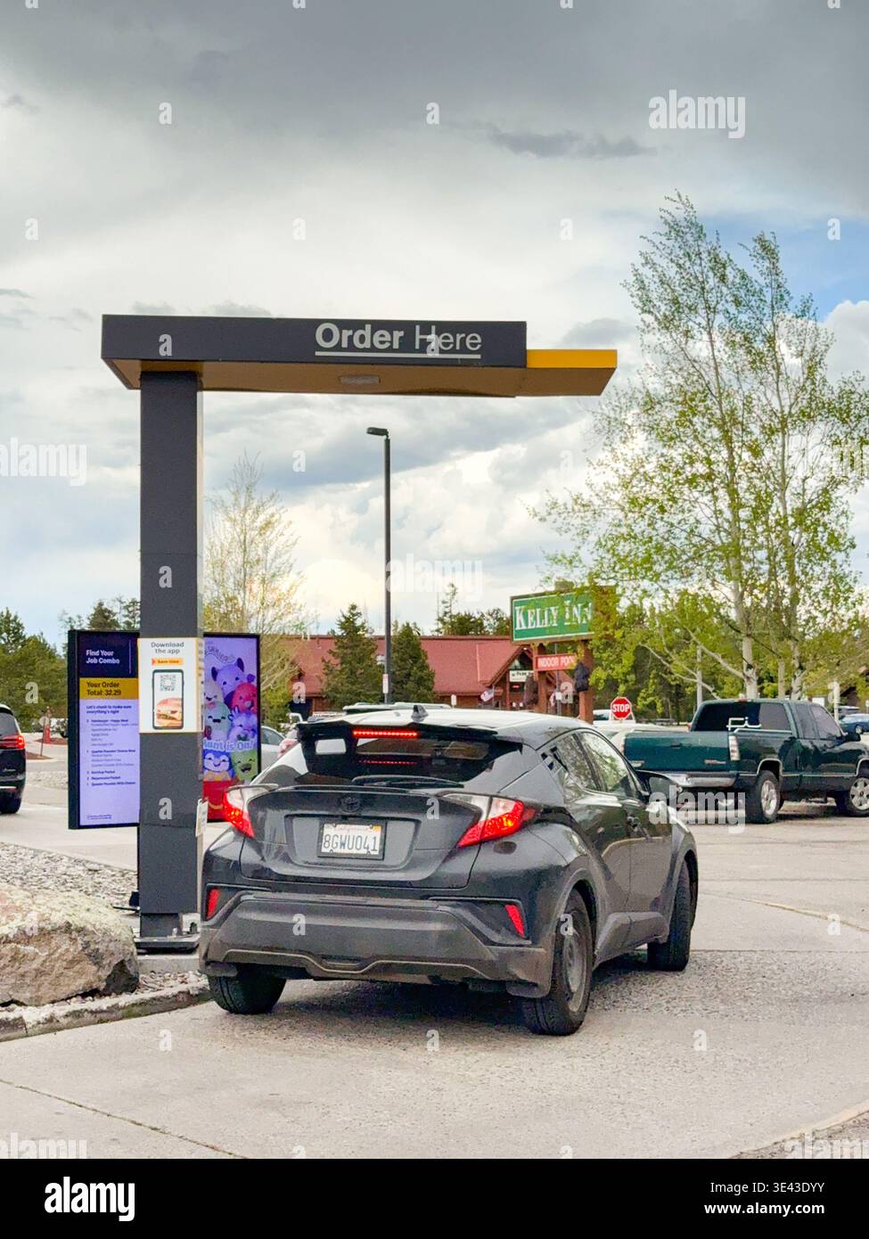 West Yellowstone, Montana, USA - 28 May 2025: Car stopped at the ordering point in a drive thru McDonald's restaurant in West Yellowstone - Smartphone Captured Stock Image