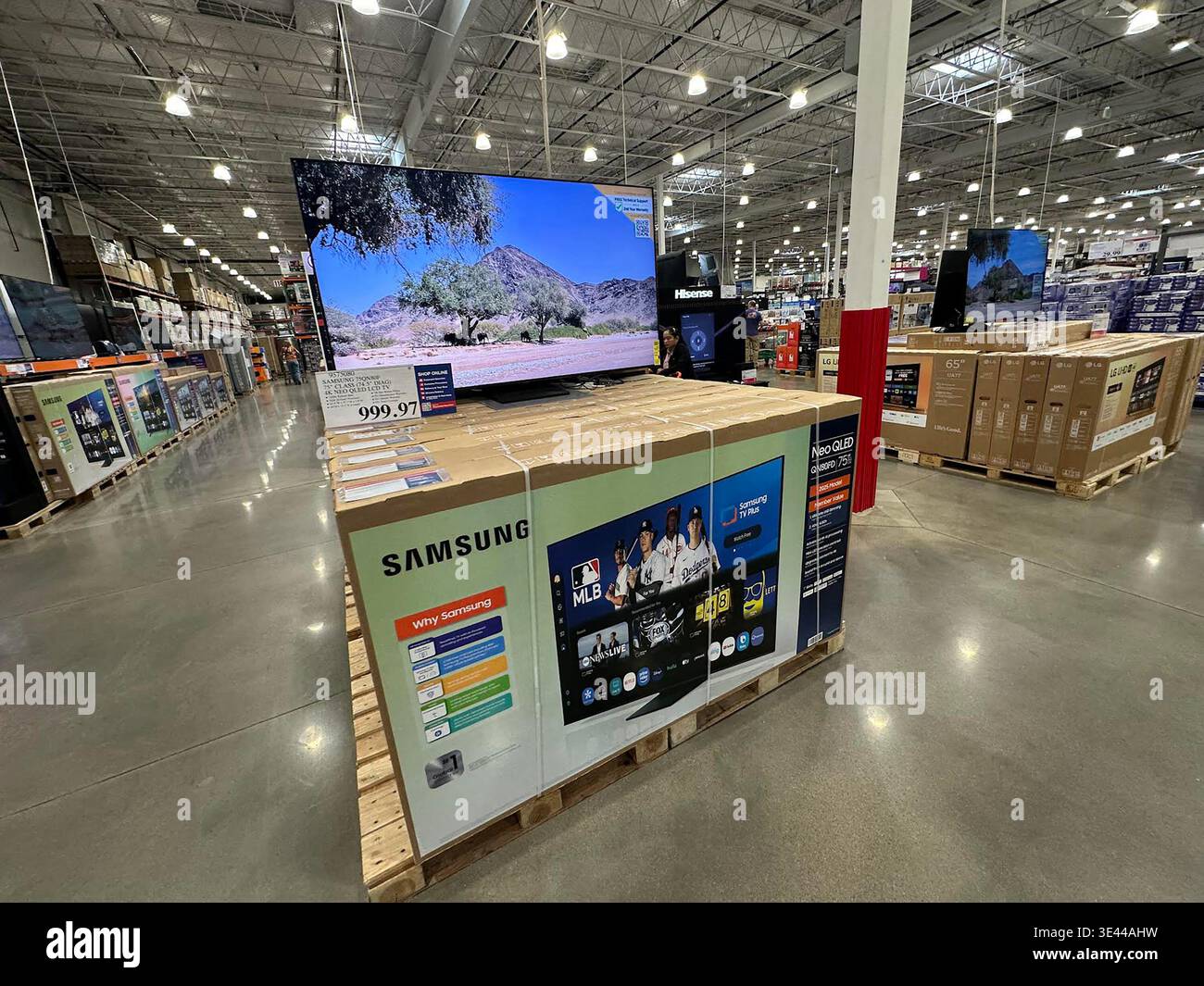 Big-screen televisions sit in shipping boxes on display for shoppers in ...