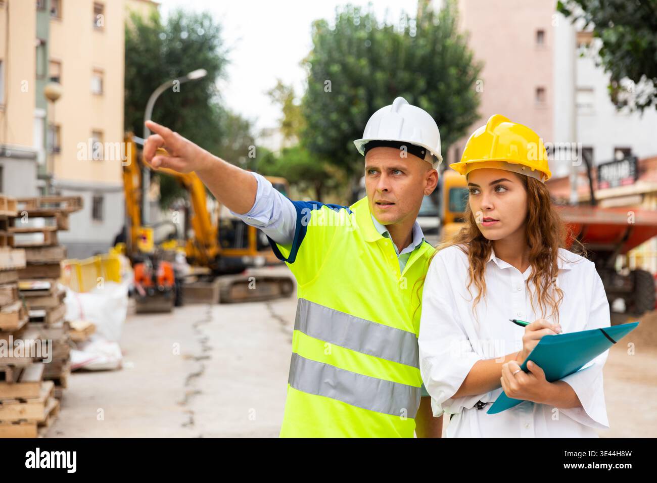 Civil engineers checking work process in construction site Stock Photo
