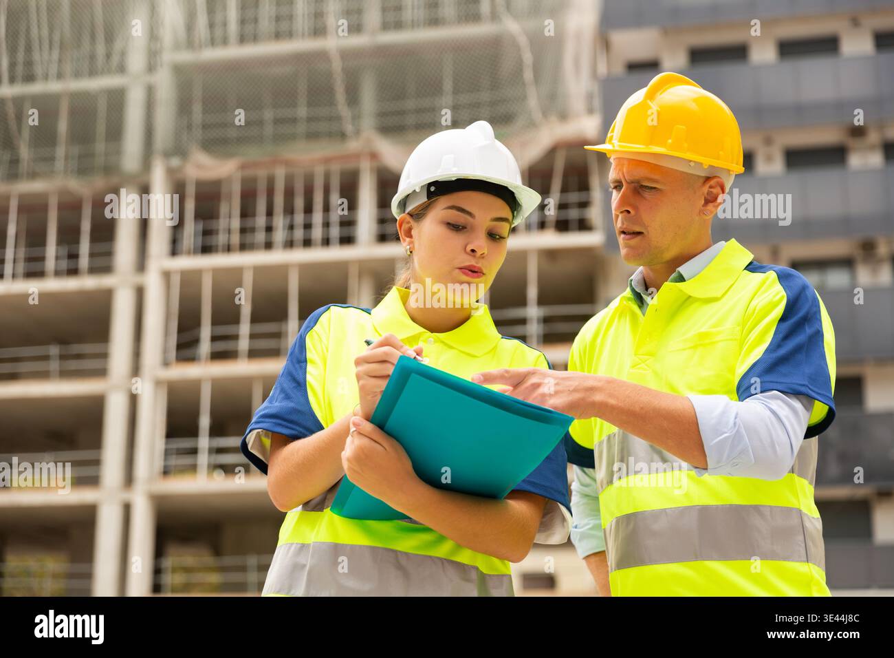 Two qualified engineers are discussing a construction plan Stock Photo
