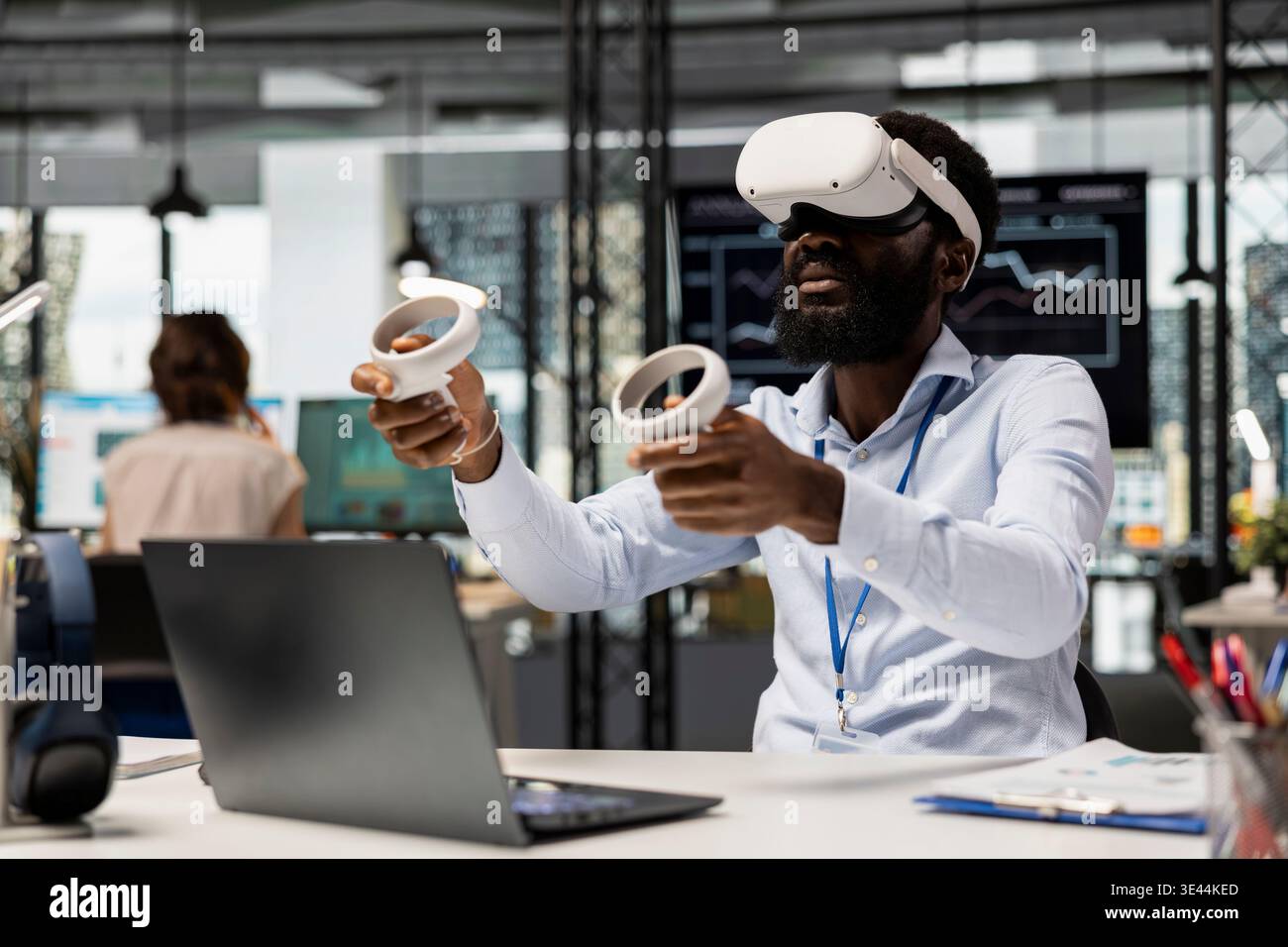 African American financial consultant uses VR goggles for augmented reality business analytics. Male office worker managing data in immersive virtual environment for project planning. Stock Photo