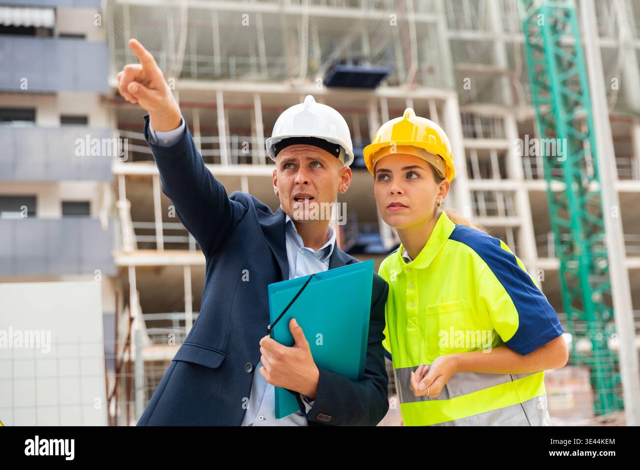 Civil engineers checking work process in construction site Stock Photo