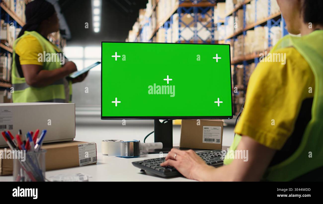 Asian employee uses a isolated mockup screen on computer monitor ...