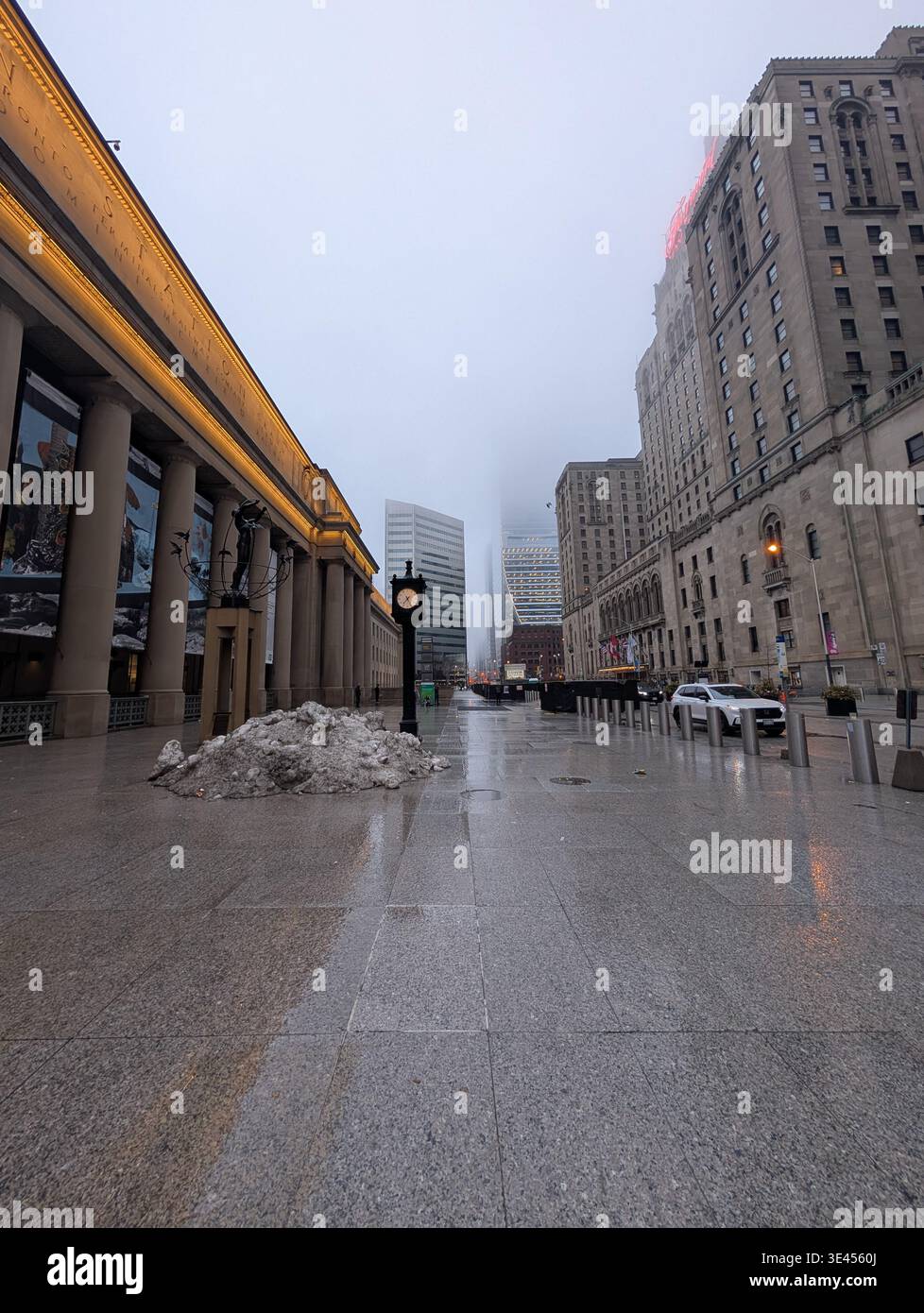 Downtown Toronto in spring - modern buildings, business district, almost empty streets covered in morning fog. A large pile of dirty snow lies in a pu - Smartphone Captured Stock Image