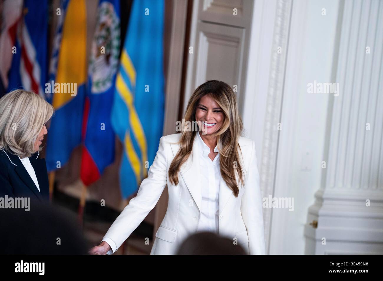 First lady Melania Trump greets Brigitte Macron as she arrives to give ...