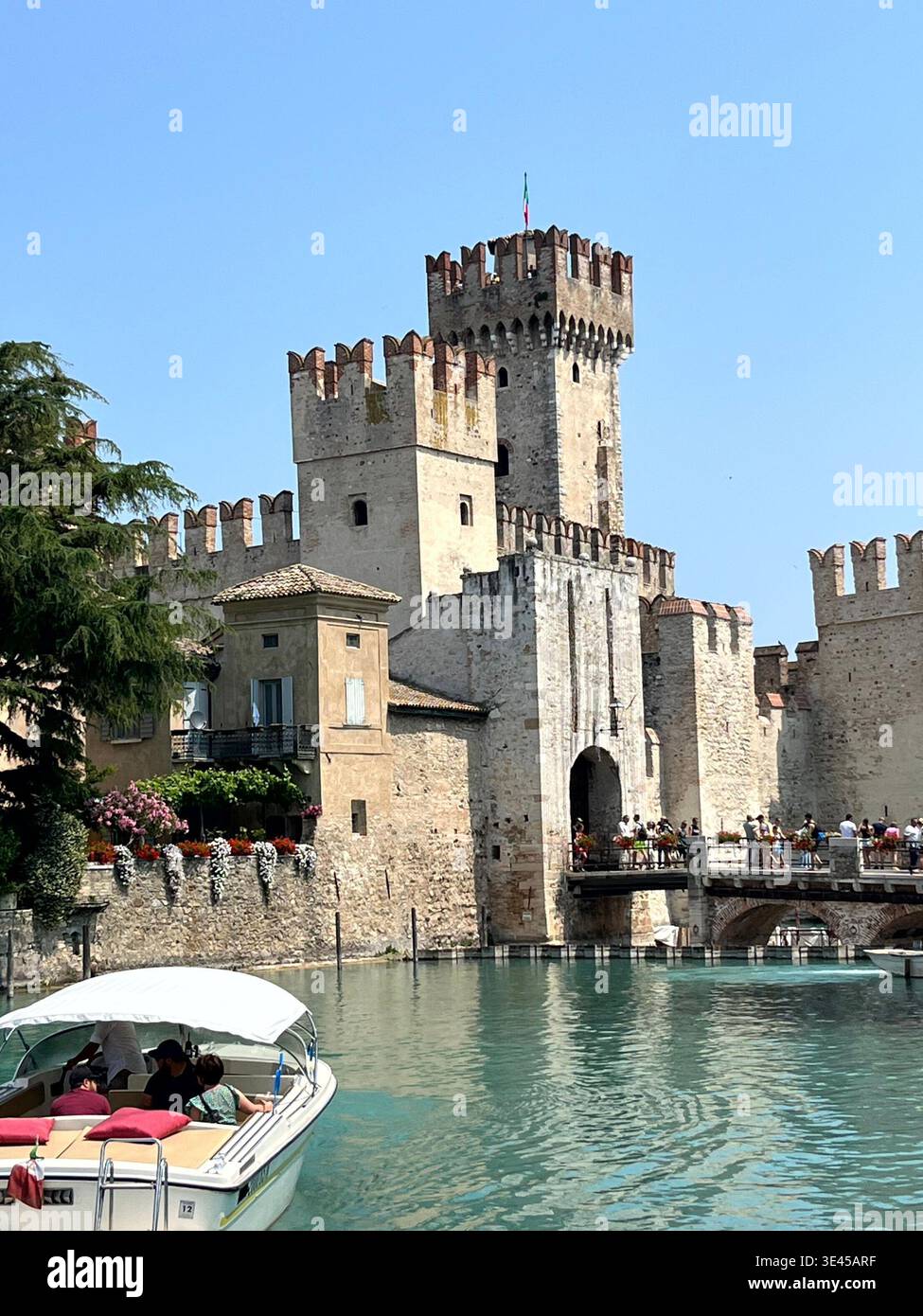 Scaligero Castle Entrance with Boat and Flowers in Sirmione Lake Garda Italy - Smartphone Captured Stock Image