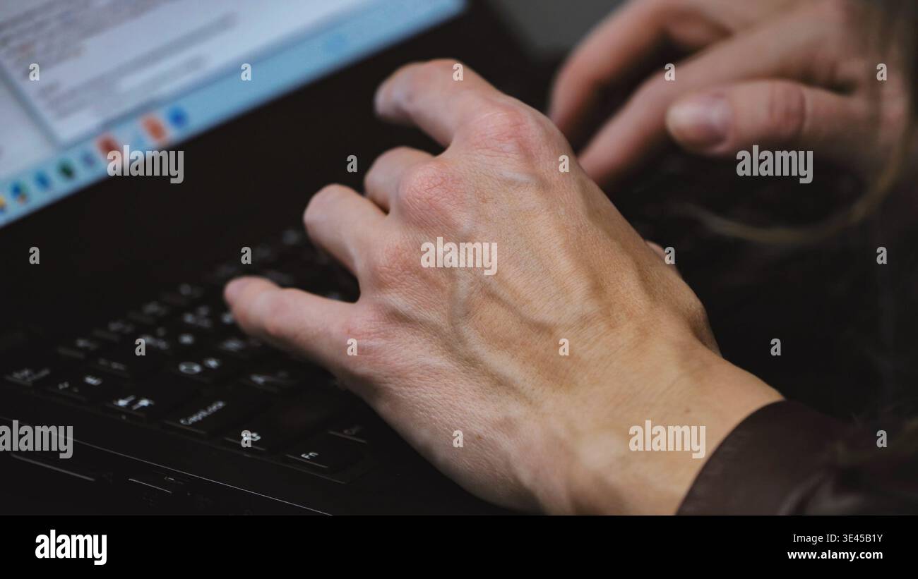 Hands typing on a laptop, performing data entry or programming work in Moscow Stock Photo